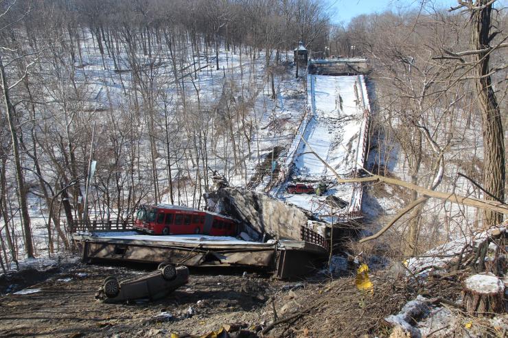 The collapsed Fern Hollow bridge, as viewed from the east approach, showing the transit bus and four of the five passenger vehicles